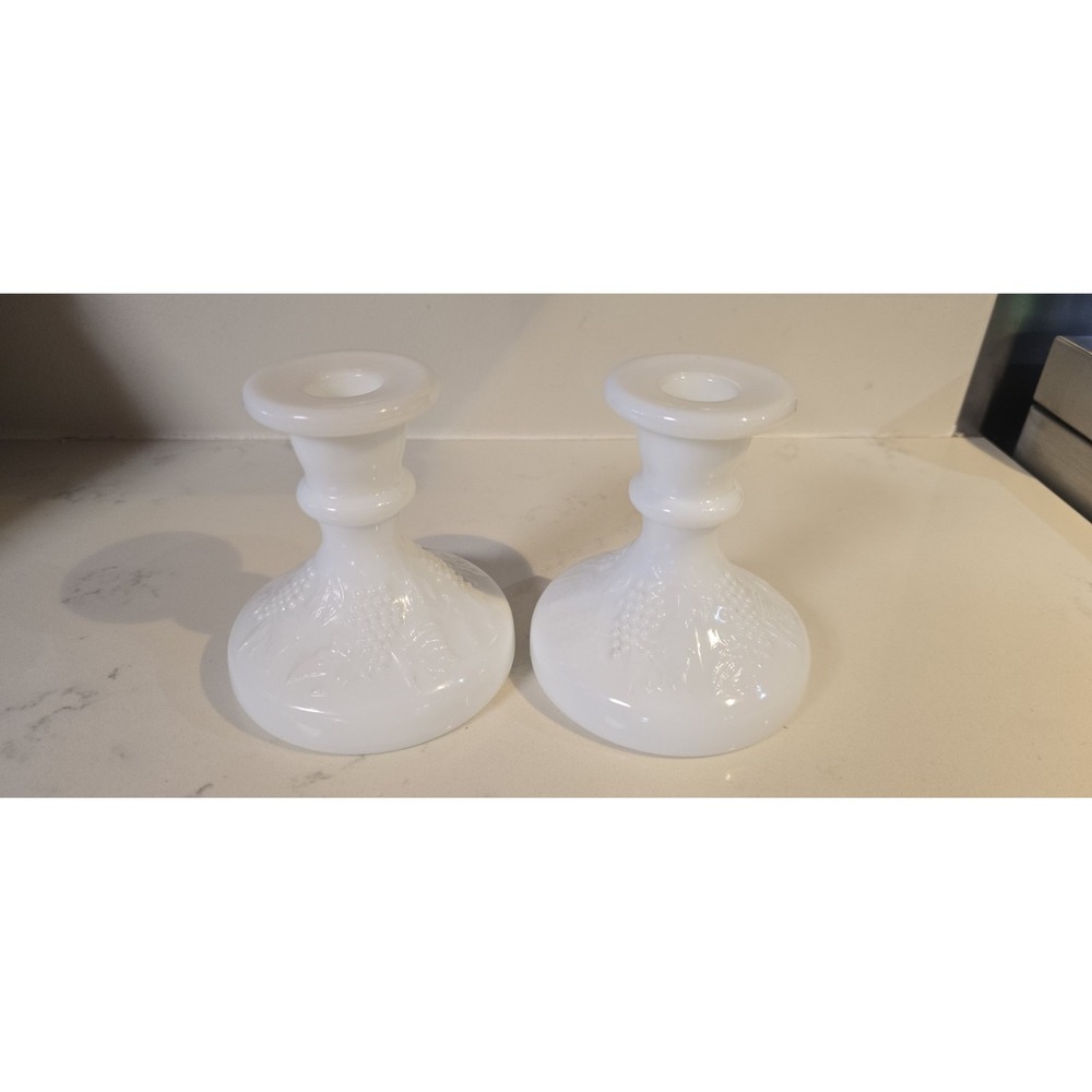 vintage white milk glass candlestick likely features a grape and vine pattern